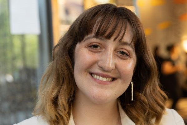 Abigail, a young woman, smiles at the camera.
