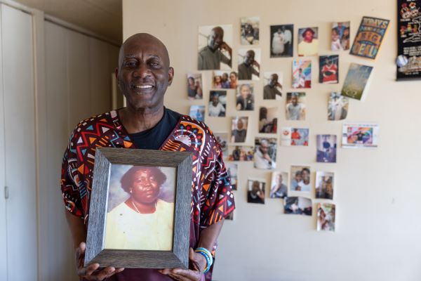 Billy holding up a photo of his mother. 