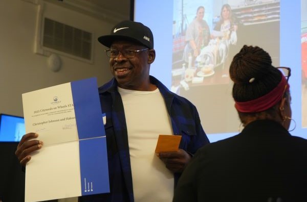 Christopher Johnson accepts his award on stage. 