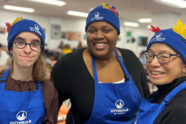 Letisha and two other volunteers dressed in Citymeals hats and aprons.