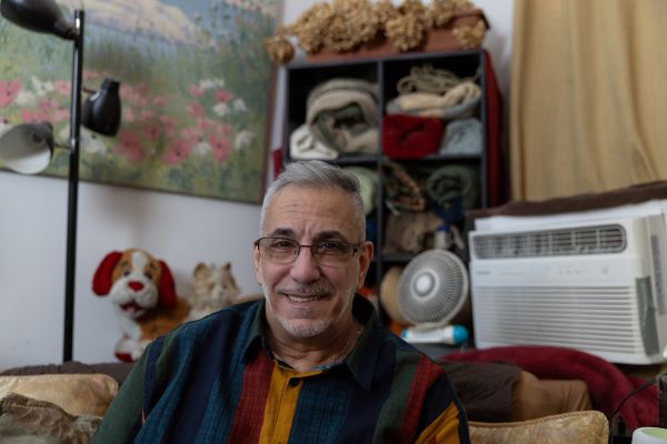 An older white man smiles at the camera. 