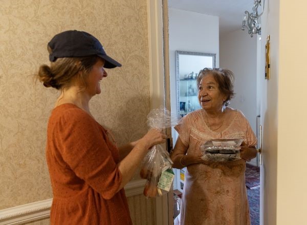 Citymeals volunteer Heather delivers a meal to a senior in New York City. 