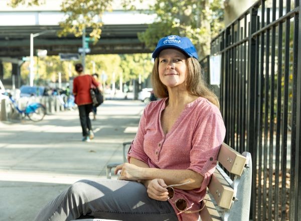 Citymeals volunteer Heather sits on a bench in Manhattan. 