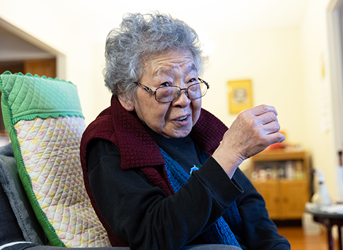 Citymeals recipient Shin Ho, an older Korean woman with square glasses and salt and pepper hair.