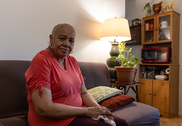 Citymeals on Wheels recipient Ileana is a senior woman with brown skin wearing a peach shirt. Her white hair is up in a bun.